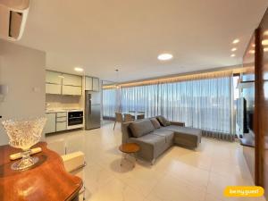 a living room with a couch and a table at JSmart - Carolina Sucupira in Fortaleza