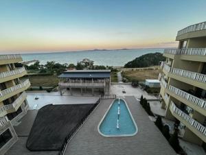 an aerial view of a swimming pool in front of two buildings at Sea View Luxury Apartment in Bŭnzareto