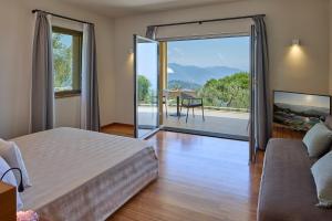 a bedroom with a bed and a sliding glass door at Il Leccio - Luxury Resort Portofino Monte in Santa Margherita Ligure