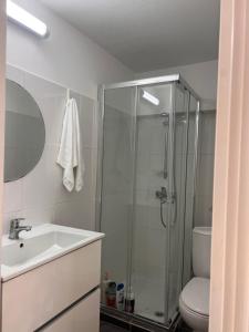 a bathroom with a shower and a sink and a toilet at Sandy Nest Studio in Larnaka +21 photos