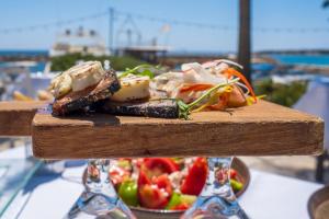 a plate of food on a table with a salad at Villa Leoforos Dyo, Modern 3Bdr Protaras Villa With Pool, In The Centre Of Protaras in Protaras