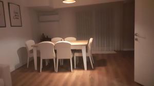 a dining room table with white chairs around it at Villa Deja Blue in Karaburun +14 photos