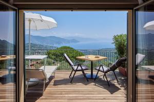 a balcony with a table and chairs and a view at Il Leccio - Luxury Resort Portofino Monte in Santa Margherita Ligure