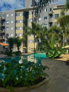 a swimming pool in front of a building at Almaré Home in Ubatuba
