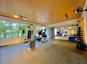 a gym with tread machines and a large window at Almaré Home in Ubatuba