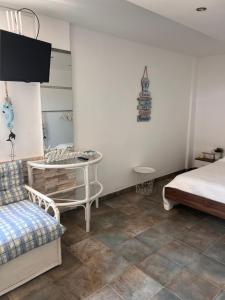 a bedroom with a bed and a table and a chair at Sandy Nest Studio in Larnaka