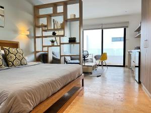 Ένα ή περισσότερα κρεβάτια σε δωμάτιο στο Moderno Estudio Increíble Roof Pool & Gym Quinta Av +41 φωτογραφίες
