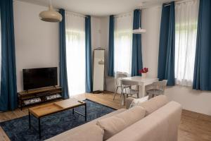 a living room with a couch and a table at Viktória Kőház Köveskál in Köveskál