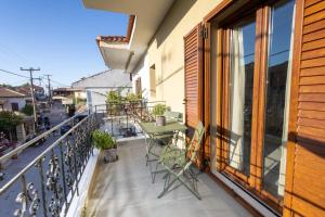 a balcony with a table and chairs at Galene in Afitos