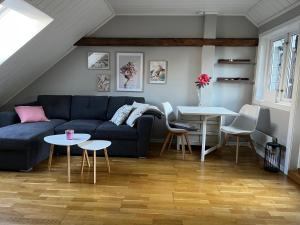 a living room with a blue couch and tables at Charming little apartment in Moss in Moss