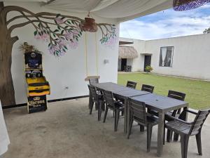 une table et des chaises assises sous une tente dans une cour dans l'établissement Casa de campo ICARO Tocaima, à Tocaima