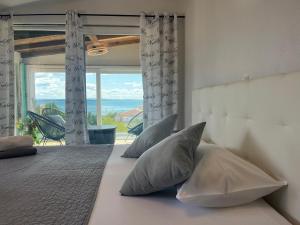 a bedroom with a bed with a view of the ocean at Four Points in Vir