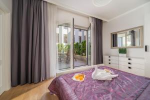 a bedroom with a bed with a swan on it at Luxury Quiet Centre - Terrace & 2 Bedrooms - 124m2 in Rīga