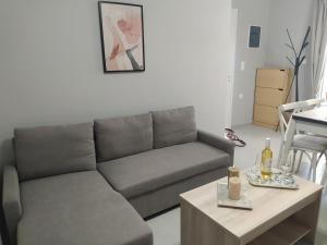 a living room with a couch and a coffee table at Dimis Apartment in Chrysoupolis