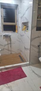 a bathroom with a shower with a television in it at Villa au centre ville Rabat in Rabat