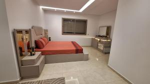a bedroom with a bed with a red blanket at Villa au centre ville Rabat in Rabat