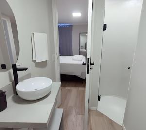 a white bathroom with a sink and a toilet at Apartamento Luxo Liberdade SP in Sao Paulo +29 photos