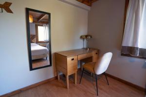 Una cama o camas en una habitación de Pioneros Suites by Grupo Tierra Gaucha
