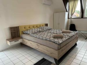 a bedroom with a large bed with a wooden frame at Dózsa Vendégház in Balatonboglár