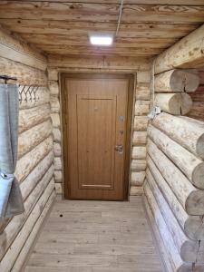 a wooden door in a room with wooden walls at Zrub pri Hrone in Brezno