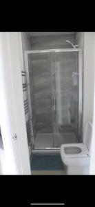 a bathroom with a shower and a white toilet at Lane Stay in Liverpool