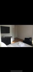 a bedroom with a bed and a desk and a television at Lane Stay in Liverpool
