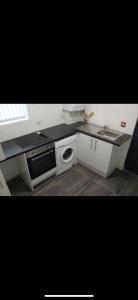 a kitchen with a sink and a stove at Lane Stay in Liverpool