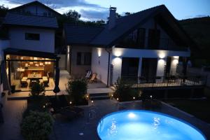 a house with a swimming pool in front of a house at Villa Utopia in Balchik