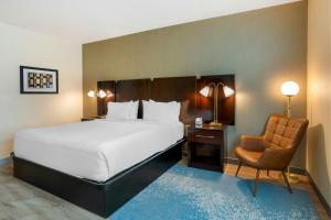 a hotel room with a bed and a chair at The Prussia Hotel - Marriott Bonvoy in King of Prussia +19 photos