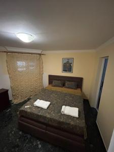 a bedroom with a bed with two towels on it at Villa VIktoria in Petrovac na Moru +20 photos