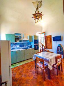 a kitchen with a wooden table and a dining room at Appartamento La Marineria in Rio Marina