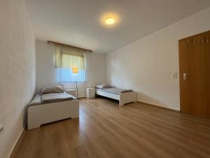 an empty room with two beds and a window at City-Apartment Monteur- & Ferienwohnung in Hagen
