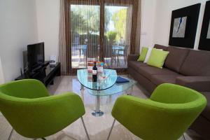 a living room with a couch and a glass table at Aphrodite Hills Junior Villas Junior Villa J009 Air Conditioning Private Pool 3 Bedrooms P in Paphos