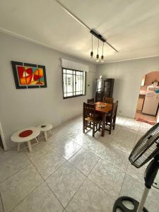 a living room with a table and a dining room at Departamento zona céntrica in San Miguel de Tucumán