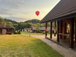 a hot air balloon flying over a building at Visockyne in Ariogala +4 photos