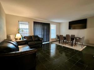 a living room with a couch and a table at By Popular Demand - Houston in Houston
