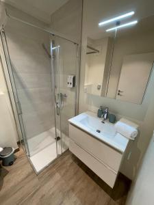 a bathroom with a shower and a sink at Stunning Wörthersee Holiday Home 15 in Sekull +81 photos