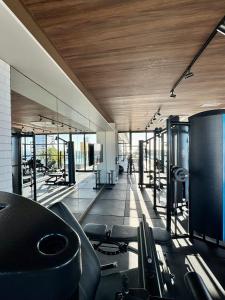 a gym with treadmills and chairs in a building at UNU 405 Loft Luxury Corredor da Vitória: piscina + in Salvador