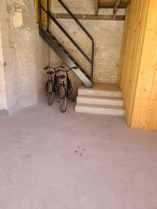 a bike parked in a building with stairs at Gîte de l'Aiguille in Civray-de-Touraine