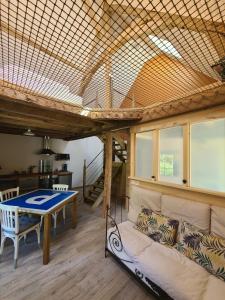 a living room with a couch and a table at Gîte de l'Aiguille in Civray-de-Touraine