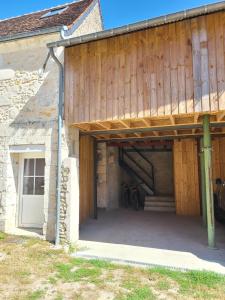 an open garage with a bike under a building at Gîte de l'Aiguille in Civray-de-Touraine