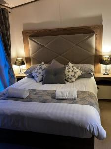 a bedroom with a large bed with pillows on it at Seascape Coastal Venture at Camber Sands in Camber