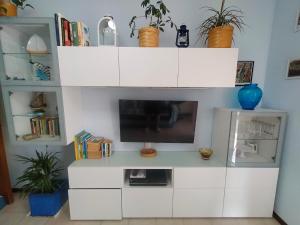 a white entertainment center with a flat screen tv at Appartamento Riviera Trilocale wifi e parcheggio privato in Ventimiglia
