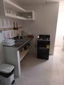 a kitchen with a sink and a stove in it at La Estrella 2 in Dosquebradas +4 photos