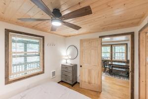 a bedroom with a ceiling fan and a piano at Bungalow, Lake Glenville, Amazing Views, & Sauna! in Cullowhee