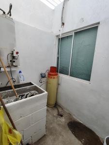 a kitchen with a sink and a window at Casa vacacional in Mazatlán