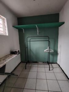 a room with a green wall and a chalkboard at Casa vacacional in Mazatlán