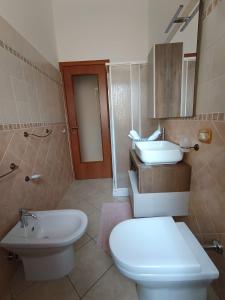 a bathroom with a toilet and a sink at CasaNorah in Fondi +18 photos