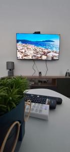 a computer monitor on a desk with a keyboard and a remote control at Harmoniya apartment in Bar