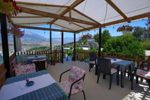 a restaurant with tables and chairs with a view at Guest House Denis in Gjirokastër